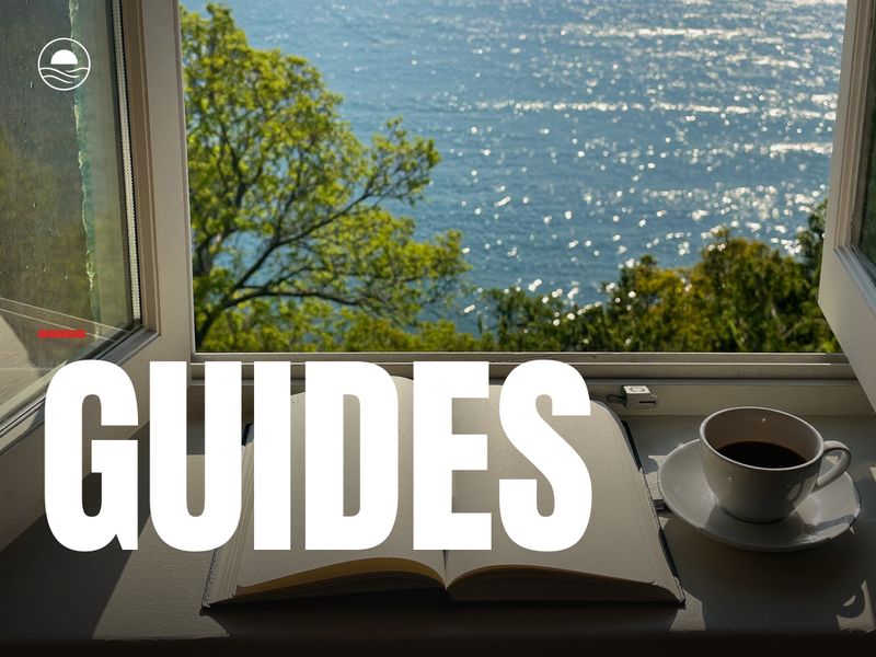 GUIDES: an open notebook and coffee on a sunny window seat over the lake