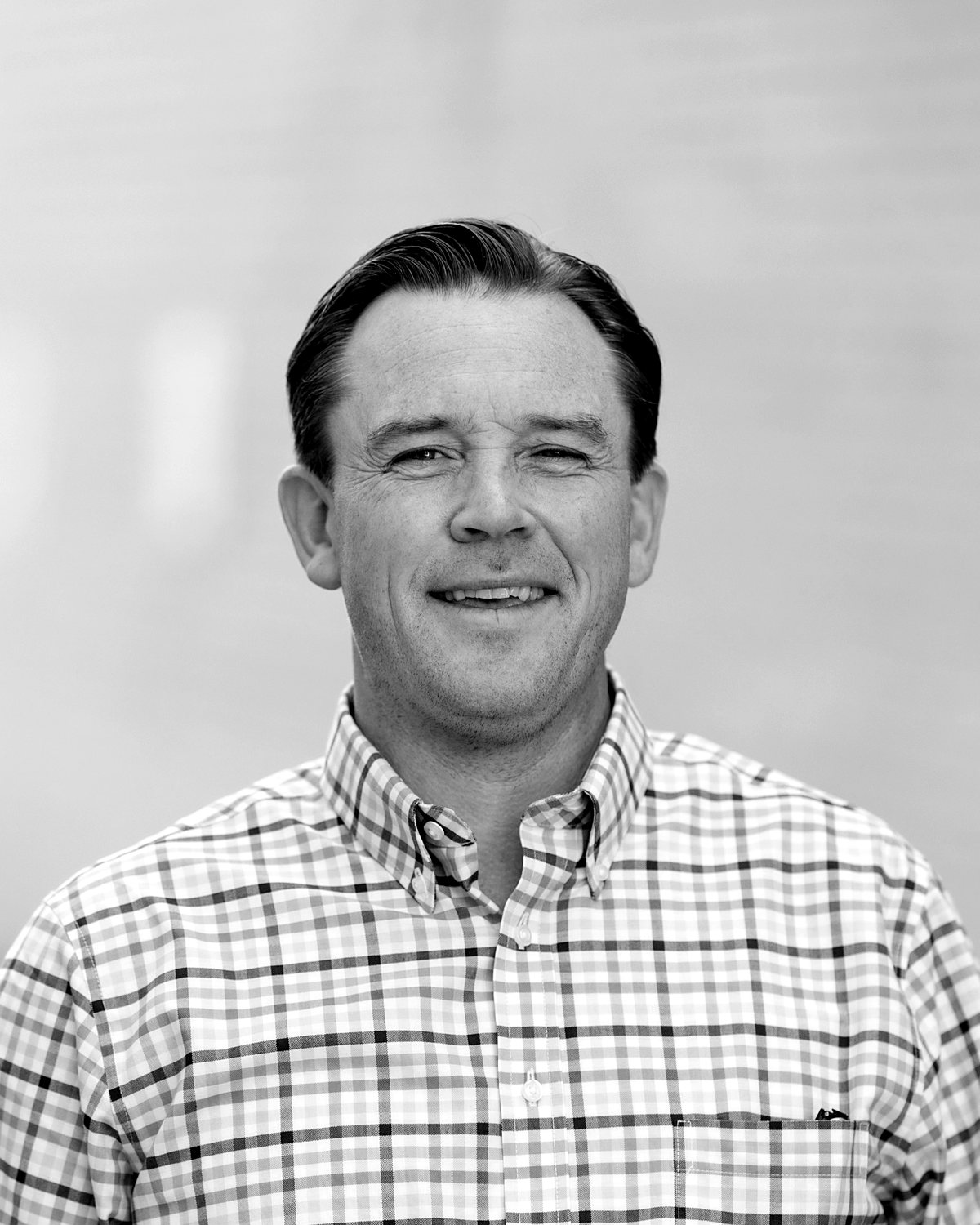 Dave Manley, smiling, black and white portrait