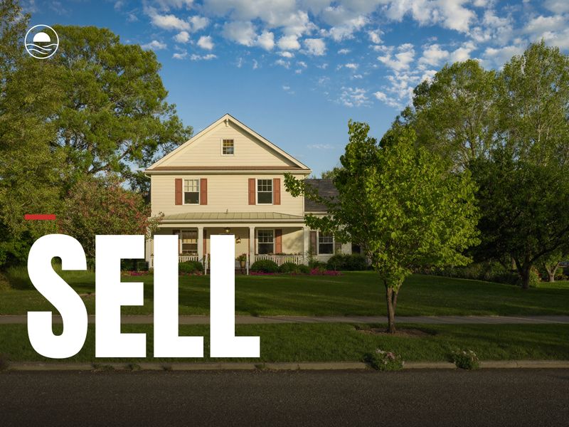 SELL: a sunny yellow farmhouse with a front porch and a green lawn